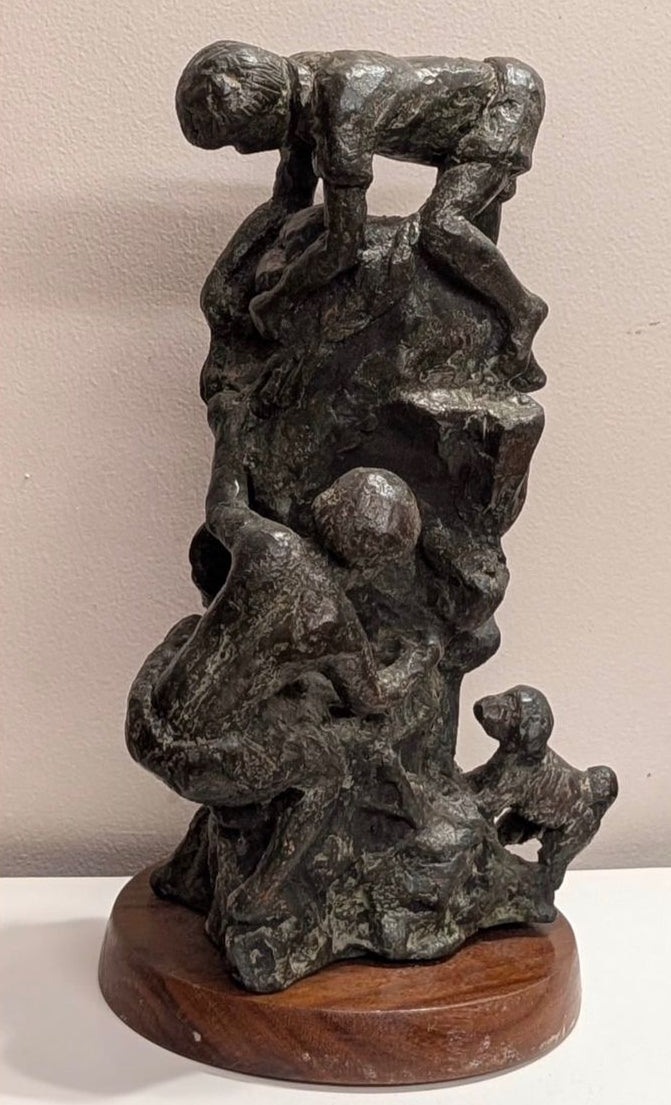 Bronze sculpture by Gauri Verma, featuring children climbing a rock.