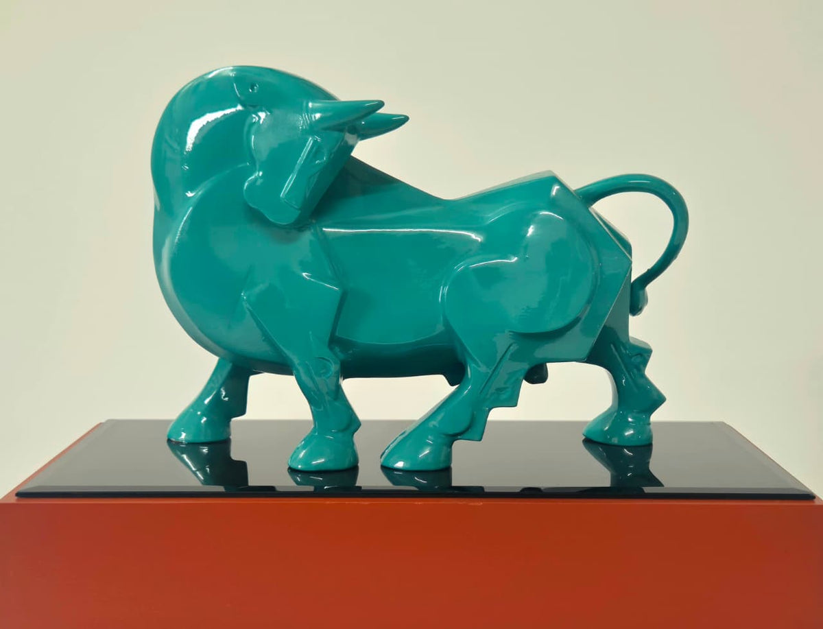 Dinkar Jadhav blue gloss finish fiberglass charging bull tabletop sculpture on red wooden base.