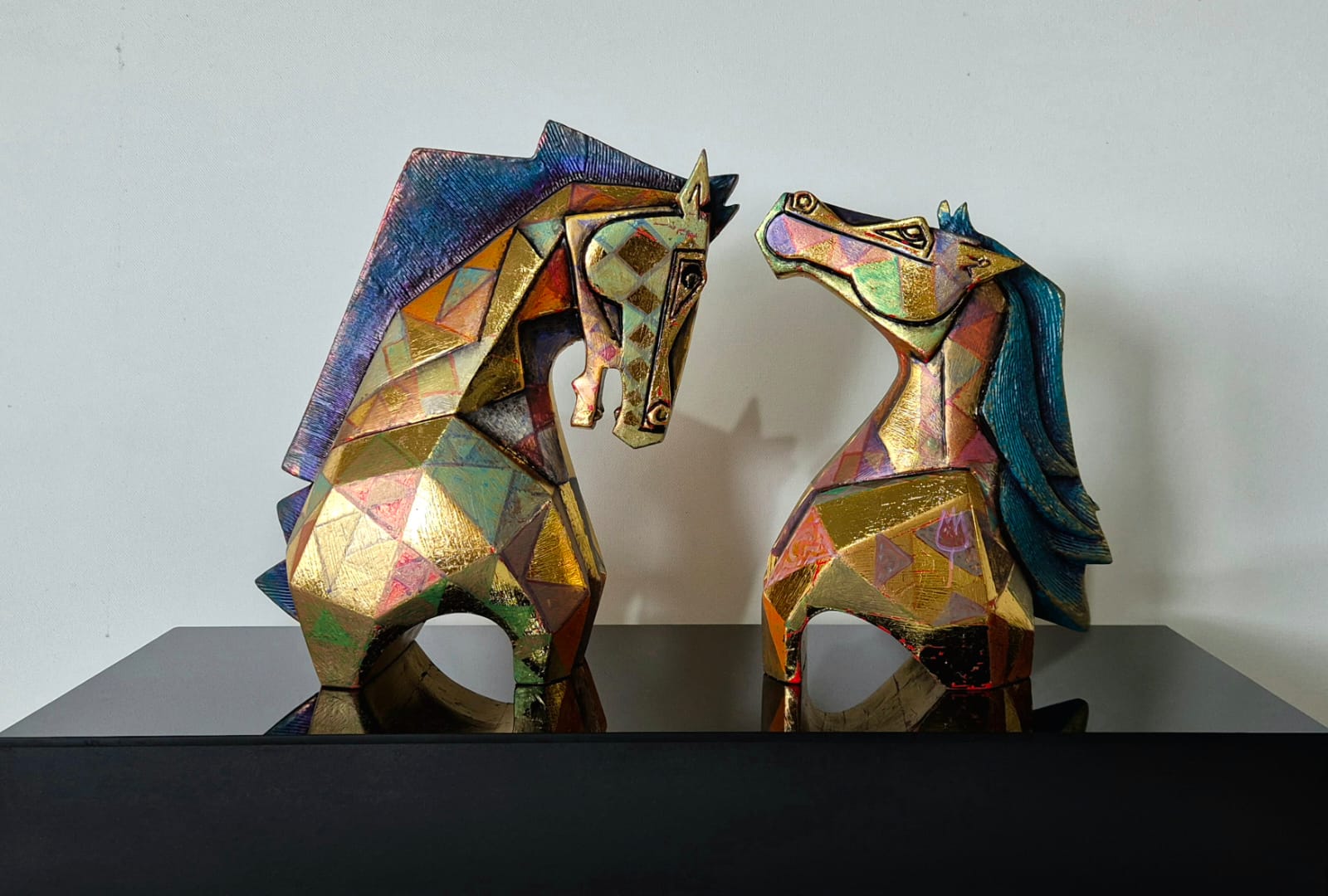 Dinkar Jadhav's limited edition fiberglass horse couple sculpture set; the gold bodies are painted in Cubist style.