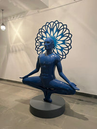Vernika Singh 6ft blue fiberglass sculpture 'I'm the Universe' showing a meditating man balancing on his toes.