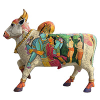Colorful bull statue with artistic designs on a white background depicting Lord shiv and Parvati. 
