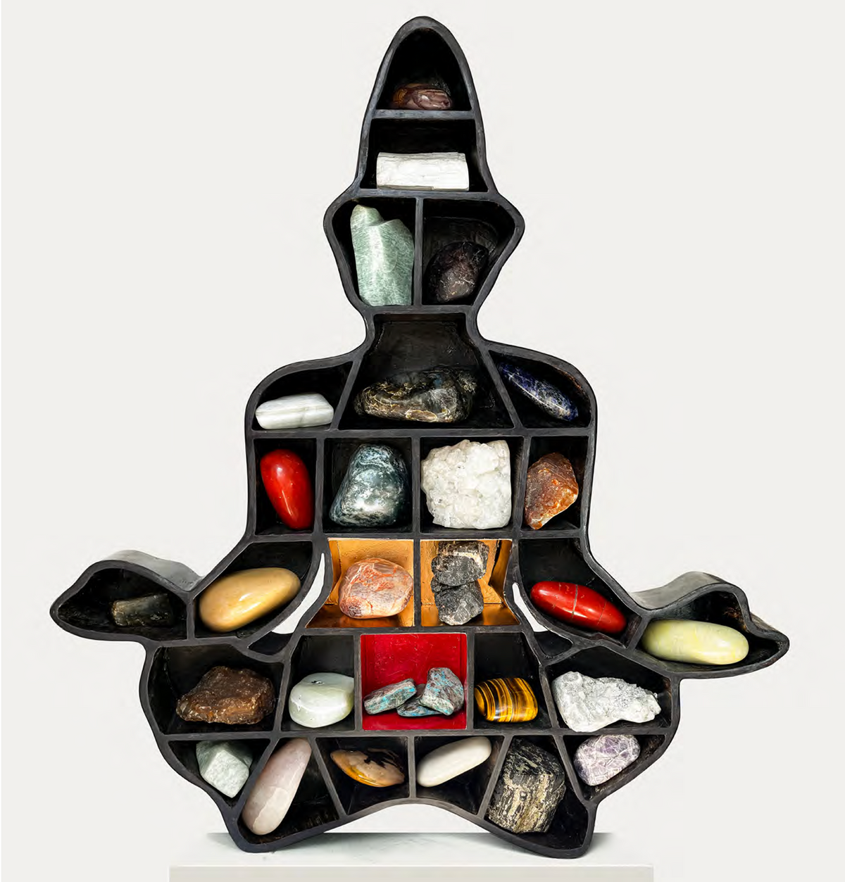 Contemporary figurative Meditating Man sculpture by Dr. Rambali Prajapati holding semi-precious gemstones.