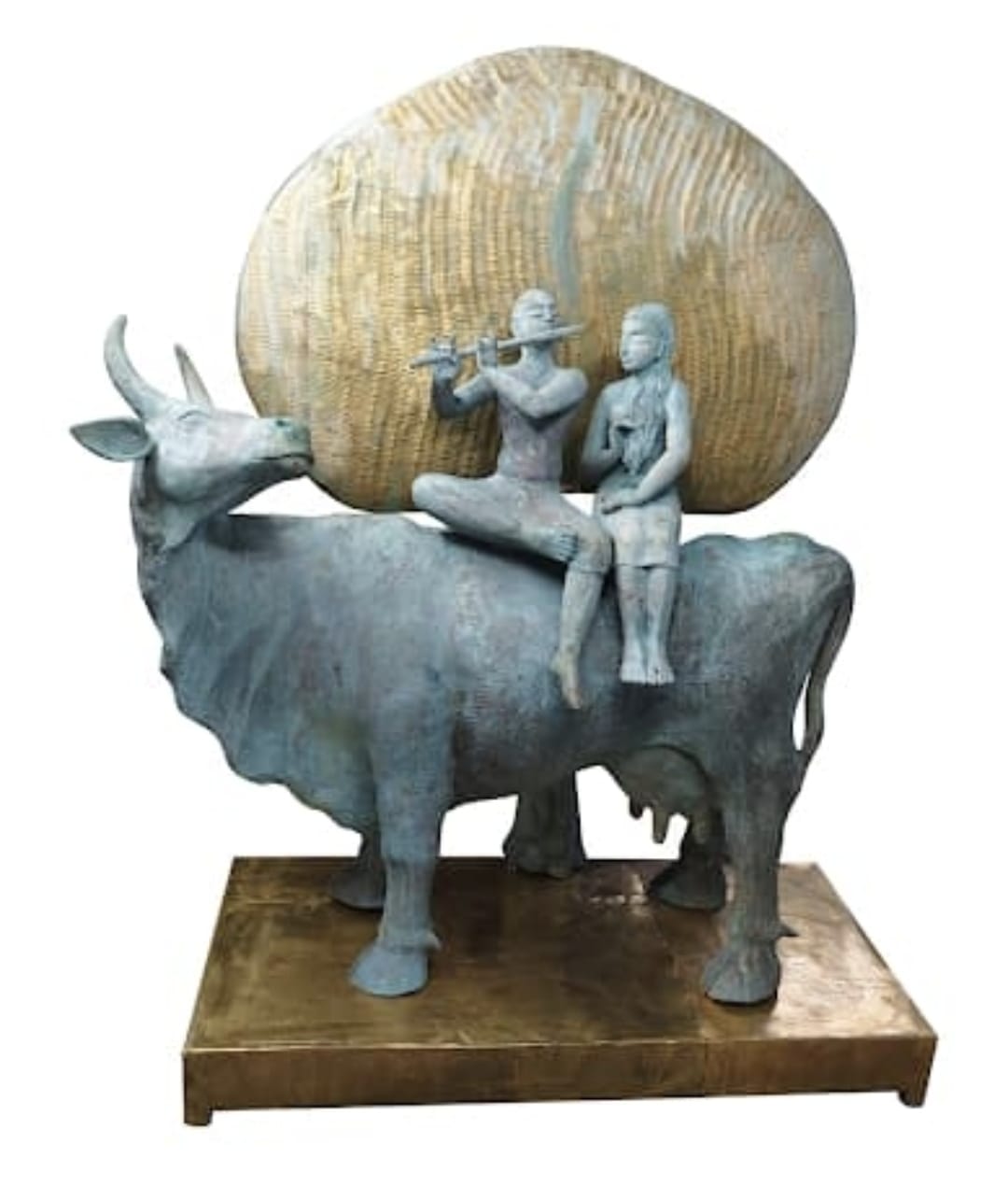 Large-scale fine art bronze sculpture by P. Gnana depicting Radha and Krishna seated on a cow under a tree canopy.