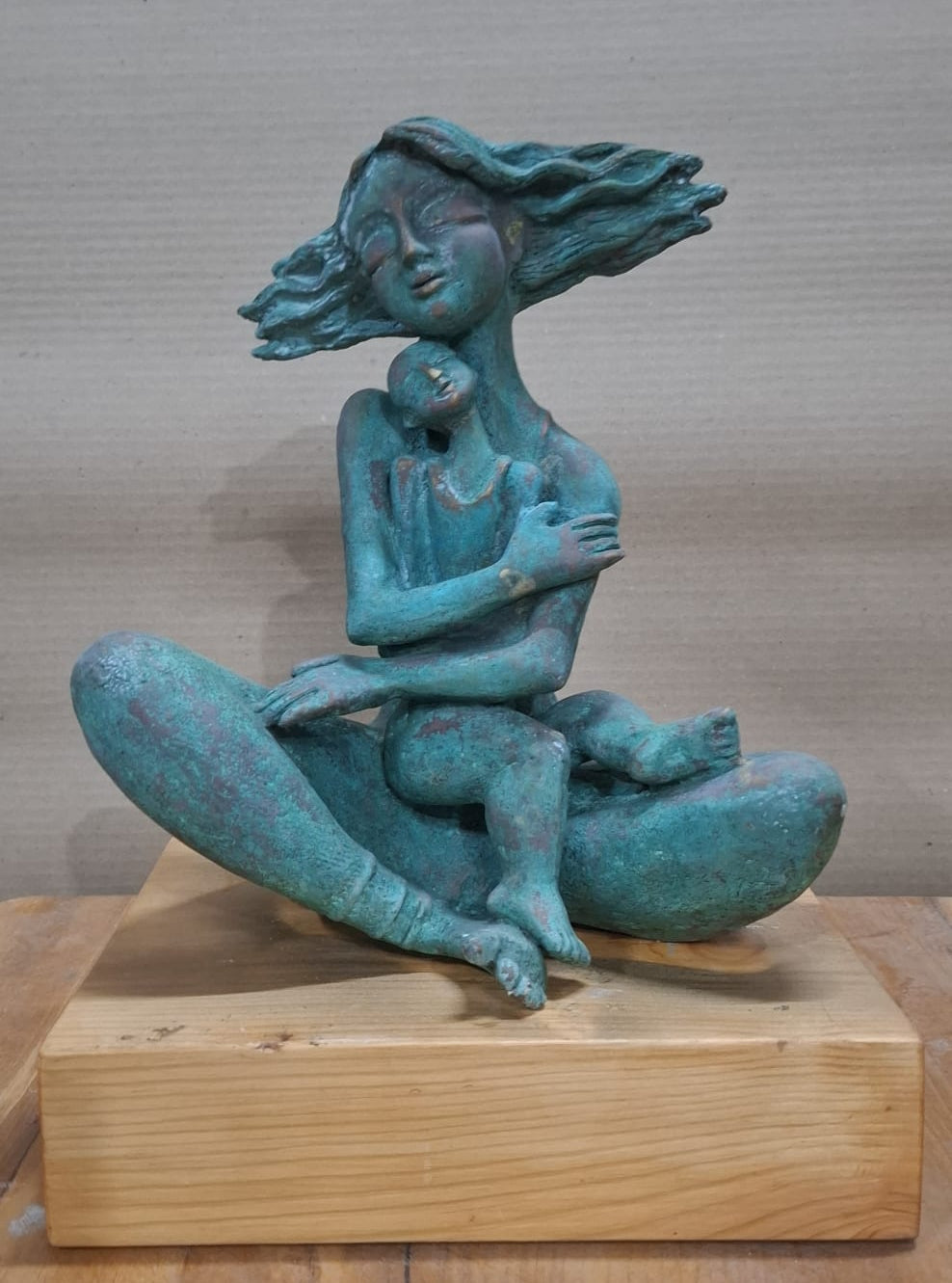 Contemporary bronze sculpture titled Reason To Live by P. Gnana depicting a mother and child locked in a tight embrace.