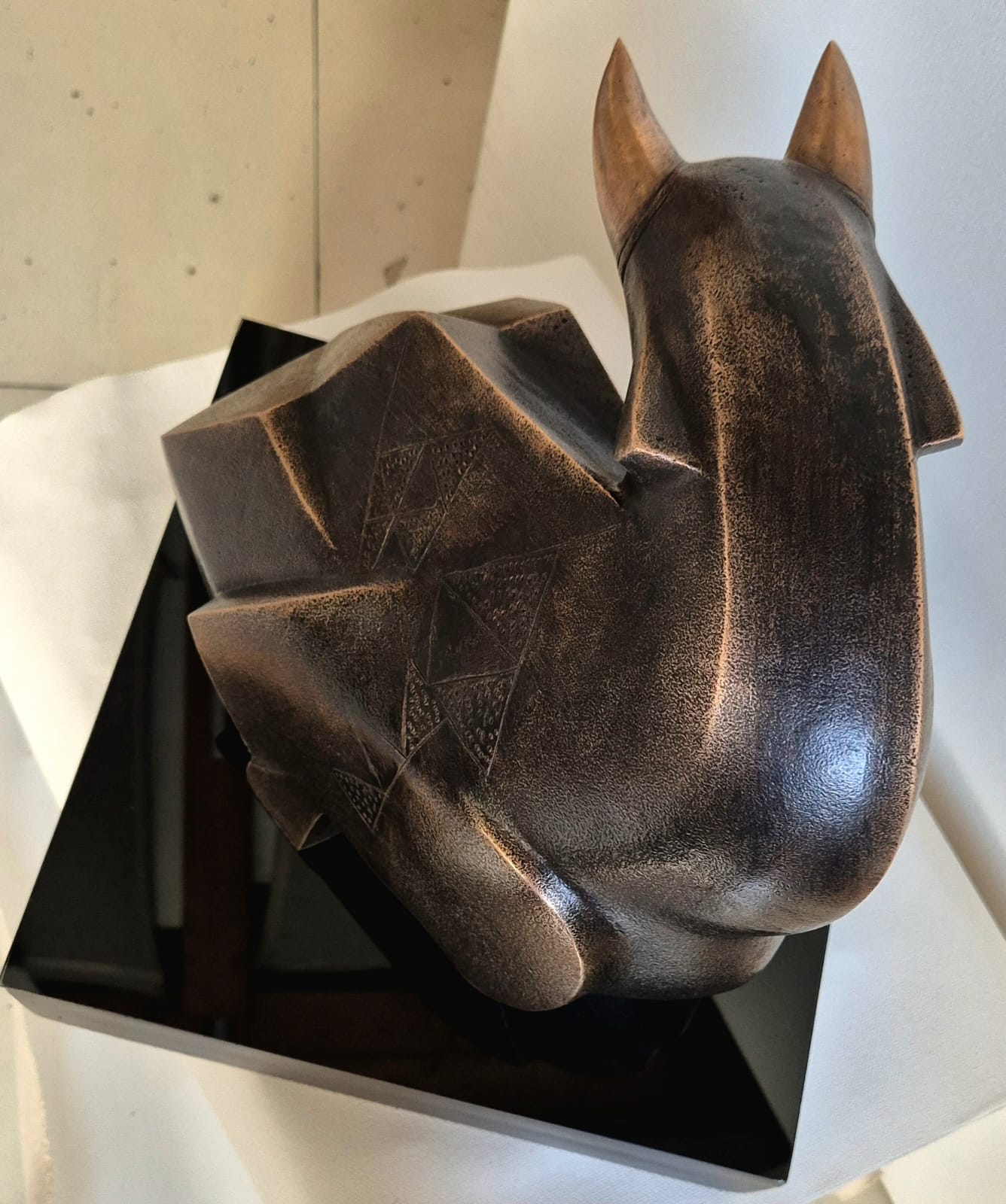 Bronze sculpture  by Dinkar Jadhav; top view close up showcases smooth body form and sharp horns.