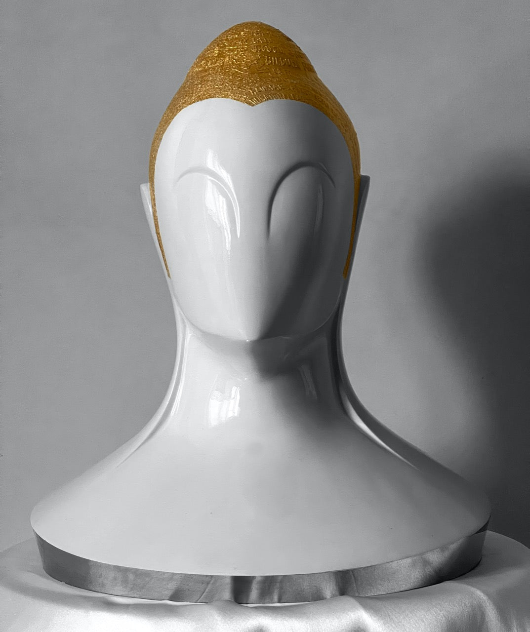 Sangeeta Abhay fine art Buddha sculpturein resin white and gold engravings on head.