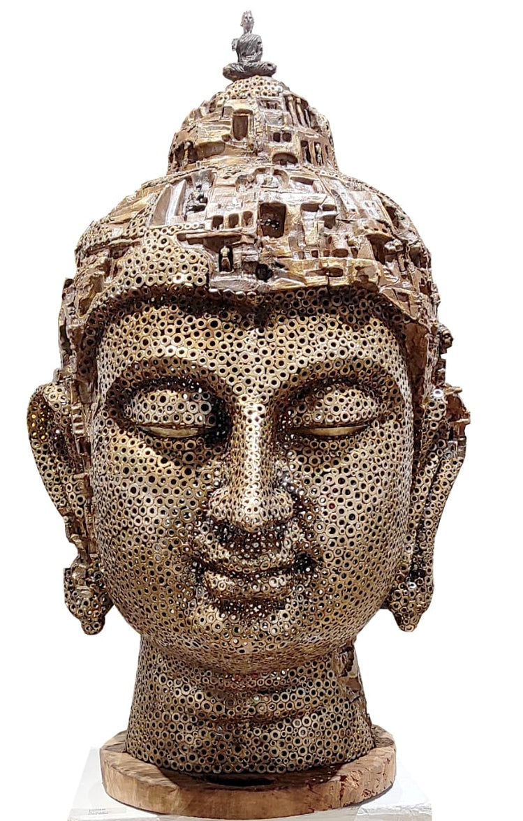 Pintu Sikder sculpture of a Buddha head with intricate detailing on a head. 