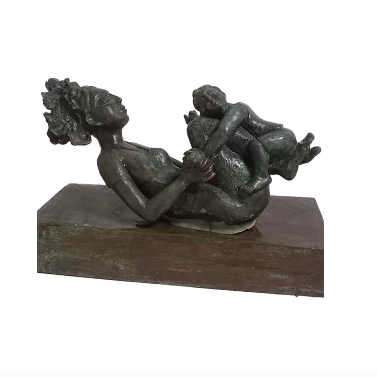 Mother swings child on her legs playfully.