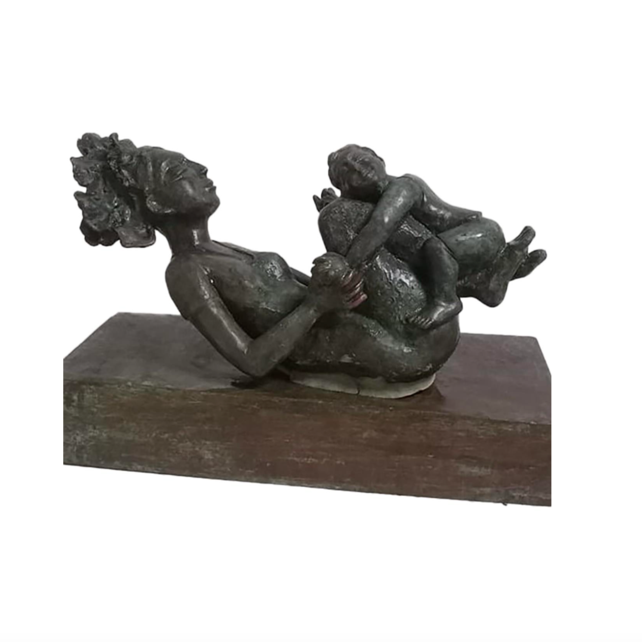 Mother swings child on her legs playfully.