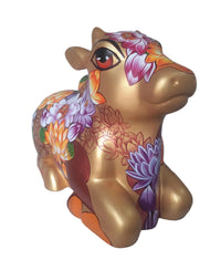 Three-quarter front view of hand-painted fiberglass Nandi - a seated bull sculpture by Sachindra Nath Jha.