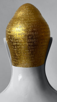 Back view of Swarnakshara Buddha head sculpture by Sangeeta Abhay.