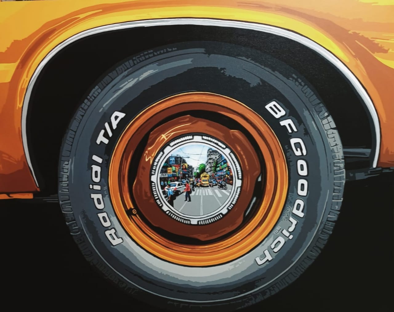 Sujit Karmakar captures the city street with intricate details in reflection within the shiny alloy of a car wheel.