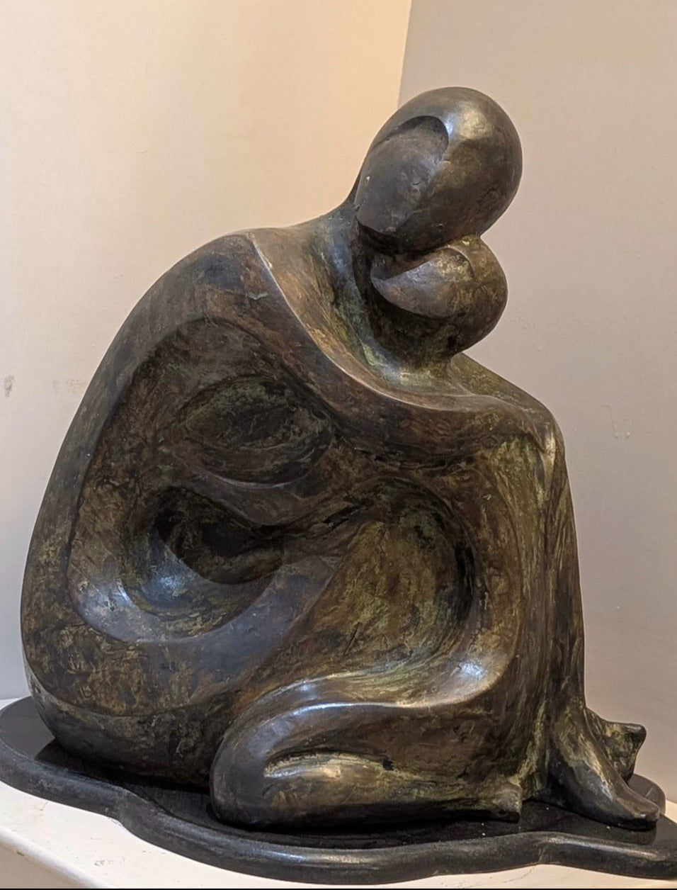 Minimalist sculpture of a couple seated in a peaceful embrace by Gauri Verma, titled Sukoon.