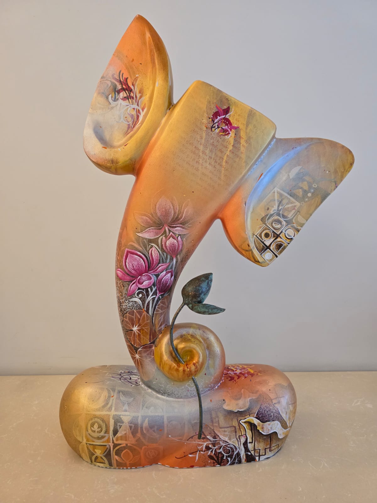 Golden yellow Ganesha fiberglass sculpture by Swati Pasari with a brass lotus flower.