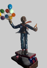 Statue of a corporate professional holding colourful balloons and beer while skating.
