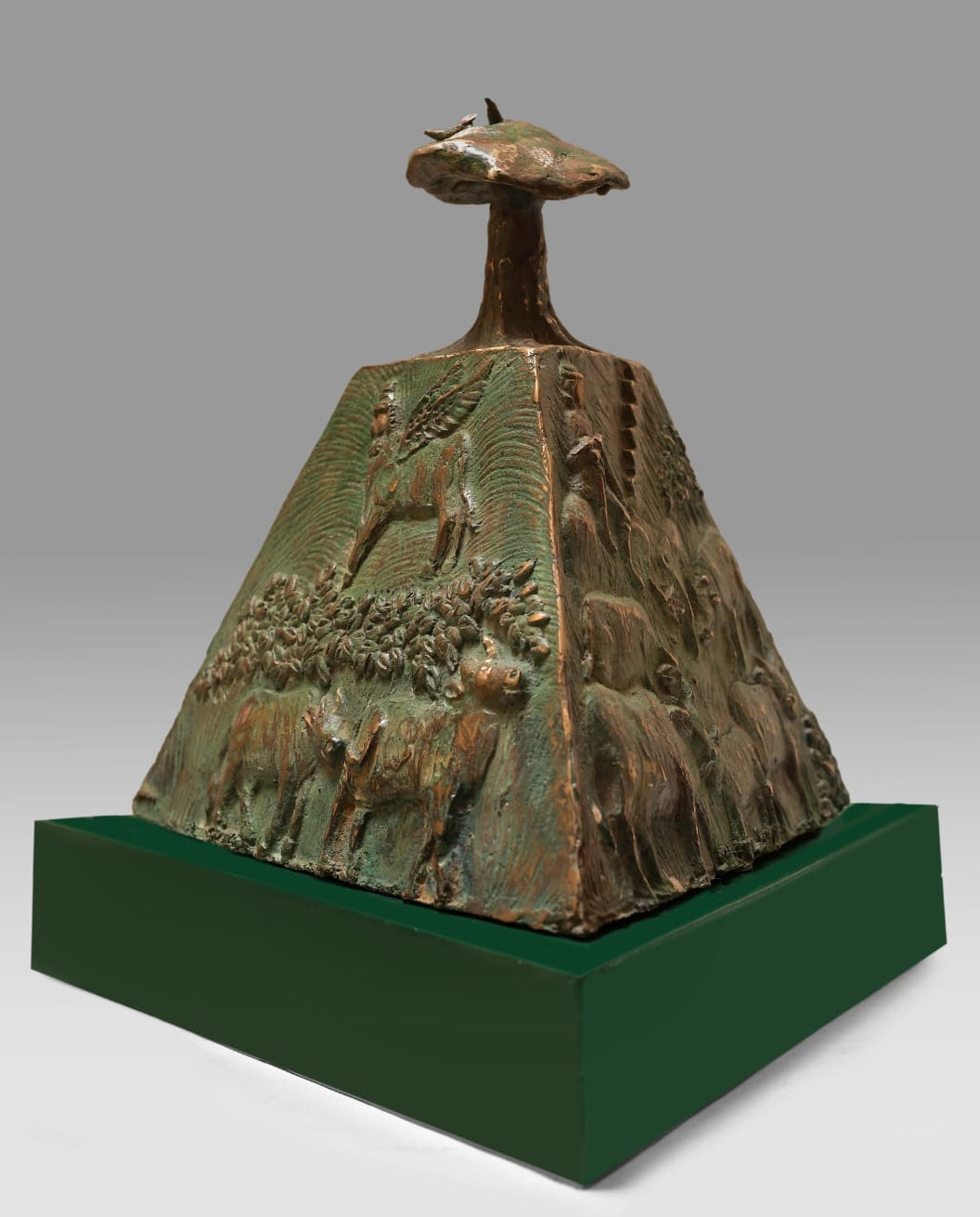 Subir Kumar Mondal's bronze conical sculpture with Kamadhenu, Krishna and nandi carvings leading to a mountain above.