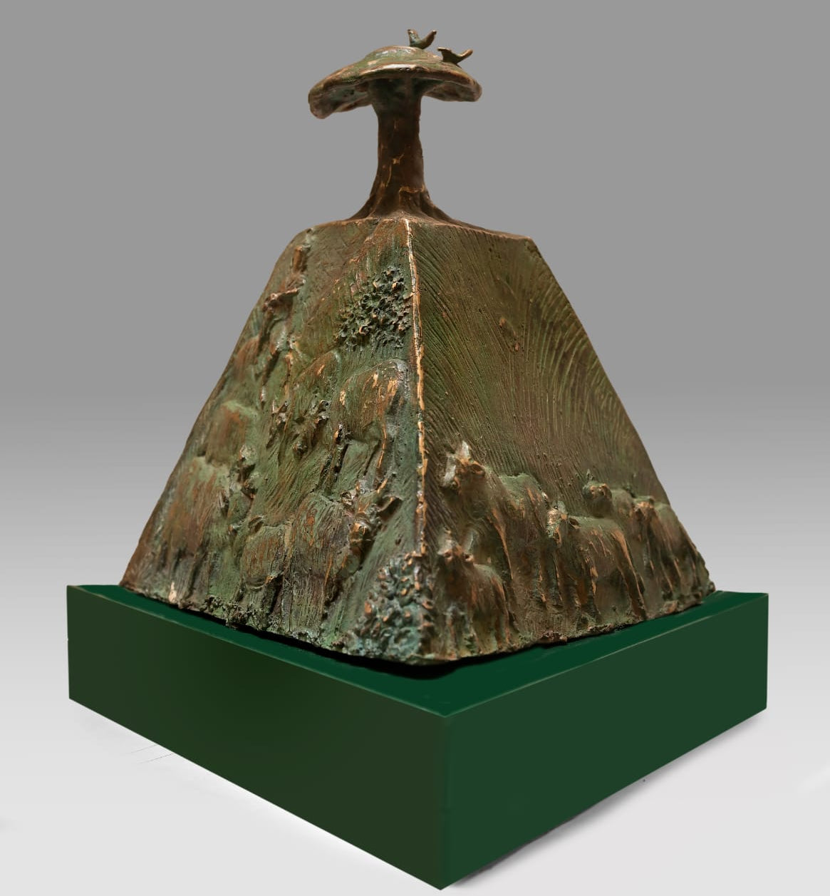 Bronze sculpture titled 'Traditional Heritage' by Subir Mondal, featuring a carved mountain on a green base.