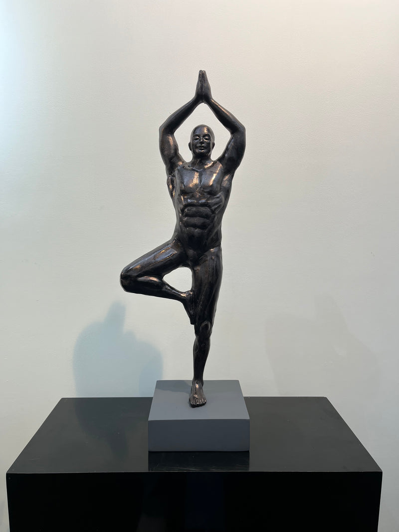 Black figure in yoga tree pose. Aluminium sculpture