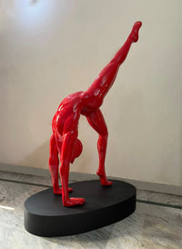 A glossy red sculpture Vernika Singh Yoga life size fiberglass sculpture.