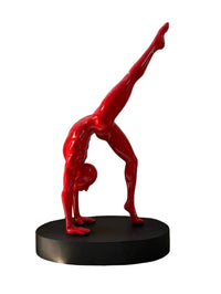 Life-size 66-inch red fiberglass sculpture by Vernika Singh depicting an agile figure in an inverted yoga pose.