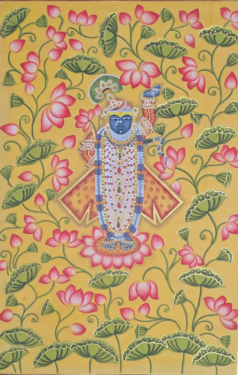 Vibrant yellow Pichwai painting of Lord Shrinathji in detailed traditional attire, surrounded by pink lotus blooms.