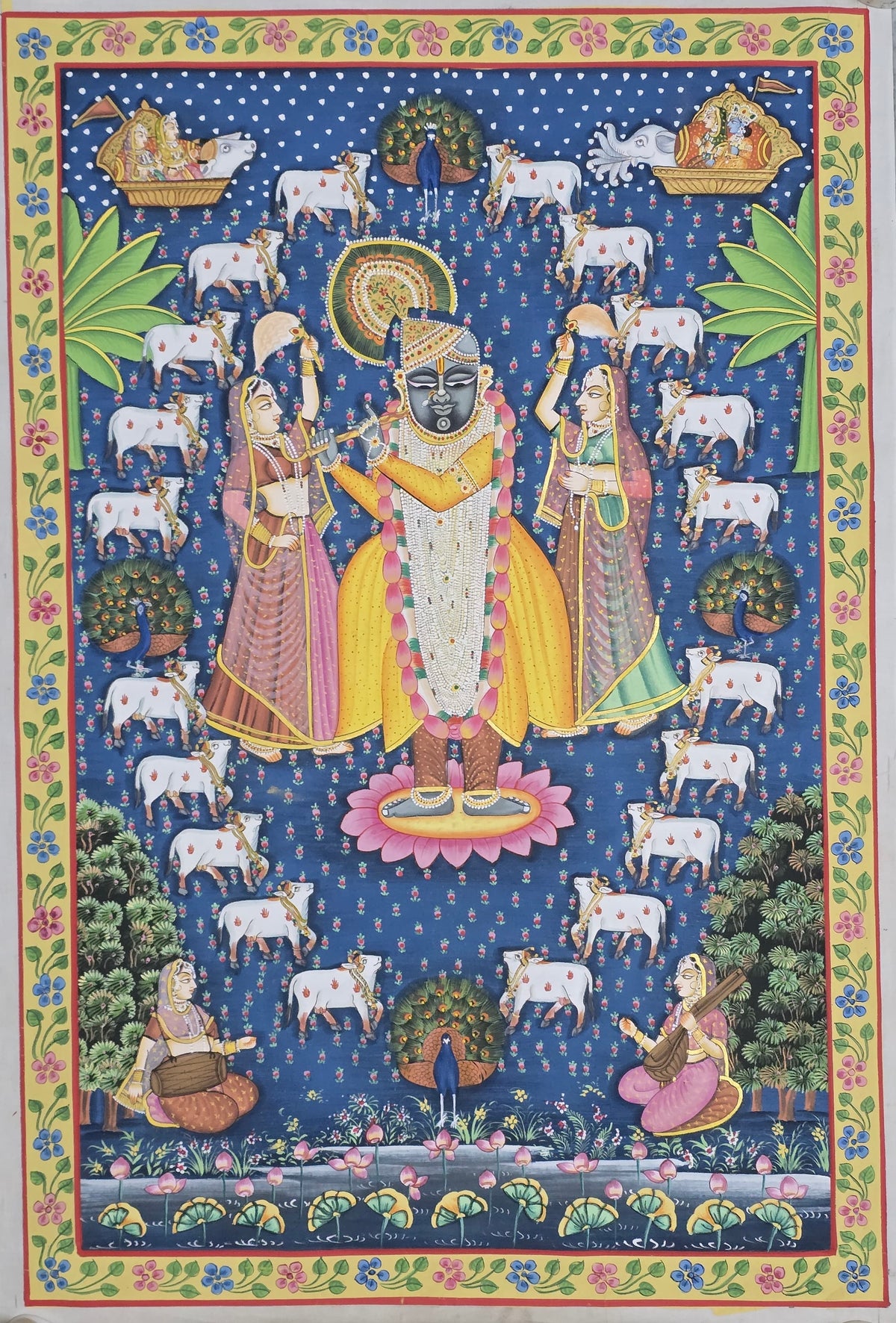 Blue tone Pichwai painting titled Shrinathji in Braj showing Lord Shrinath flanked by Gopis and surrounded by a circle of devoted Nandis.