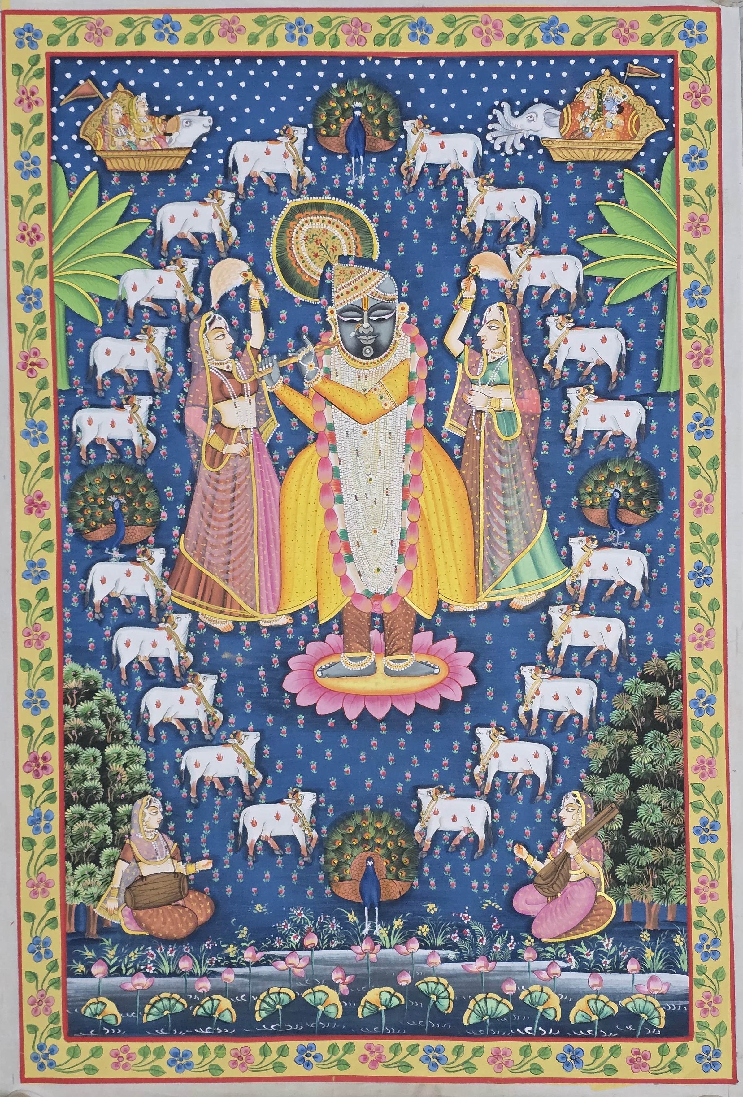 Blue tone Pichwai painting titled Shrinathji in Braj showing Lord Shrinath flanked by Gopis and surrounded by a circle of devoted Nandis.