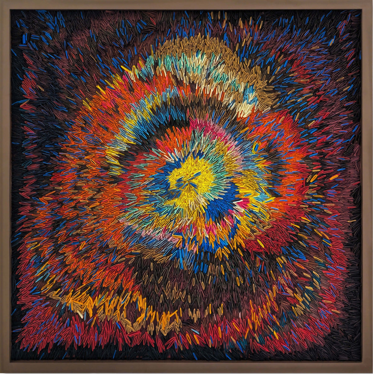 Colorful spiral mixed media art piece on a black background with a wooden frame by P Suresh.