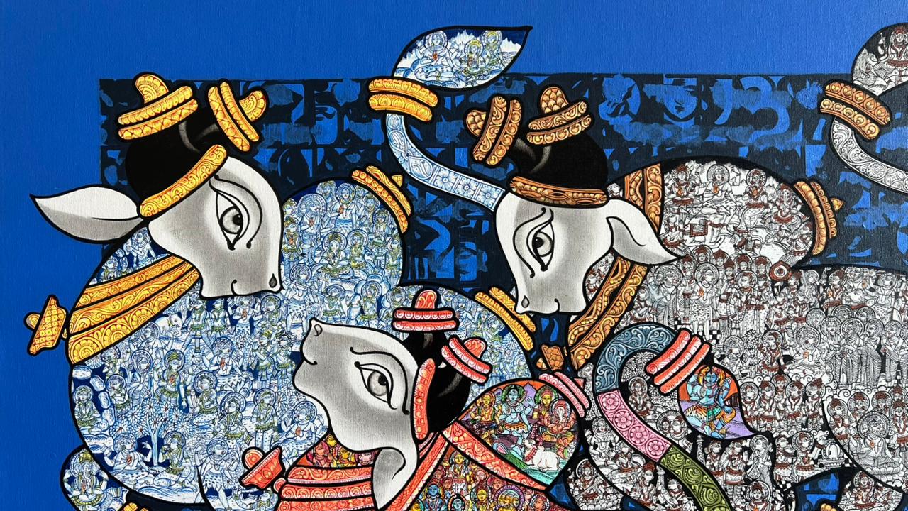 Decorative artwork of three cows with colorful patterns on a blue background.
